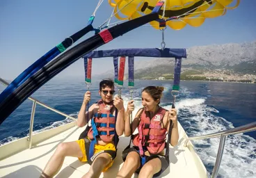 Happy tourists parasailing